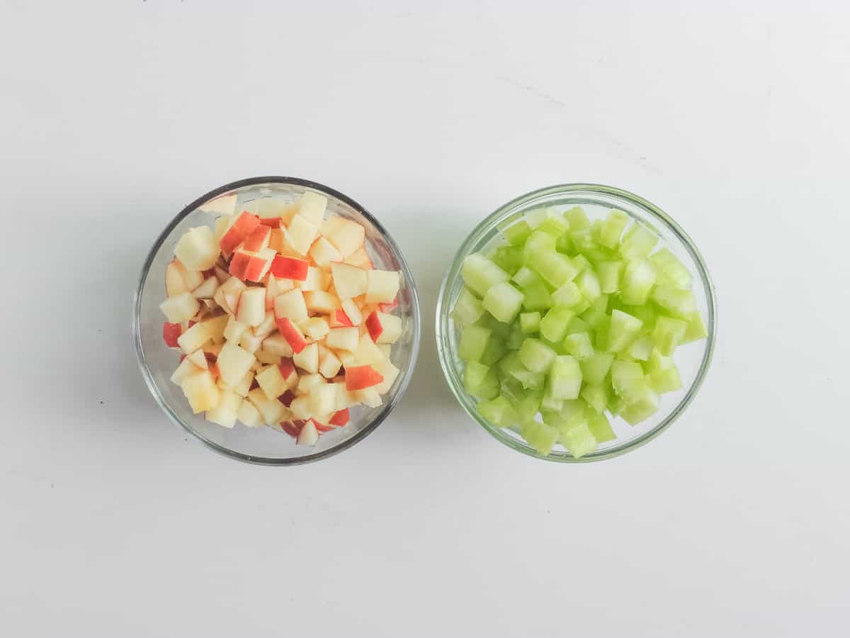 bowls of chopped apple and chopped celery.