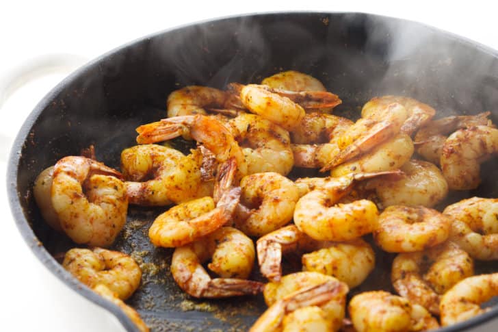cooked seasoned shrimp in a skillet.