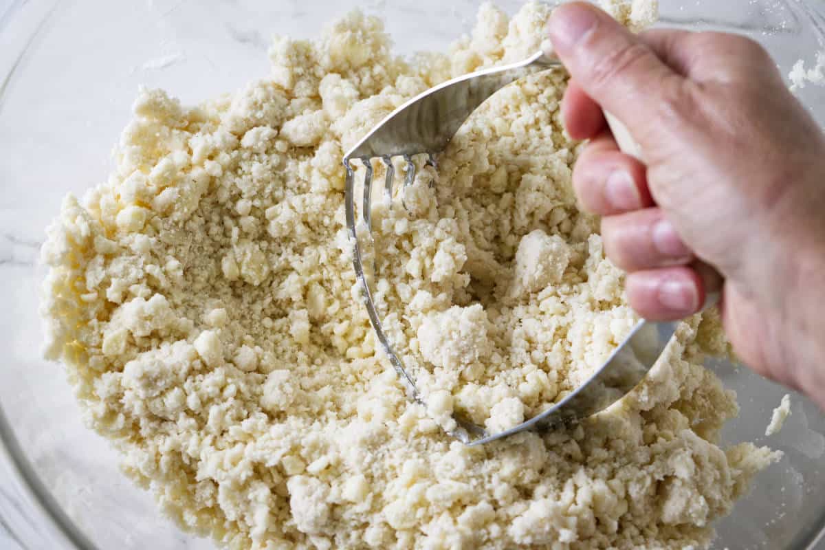cutting flour & shortening into the flour.