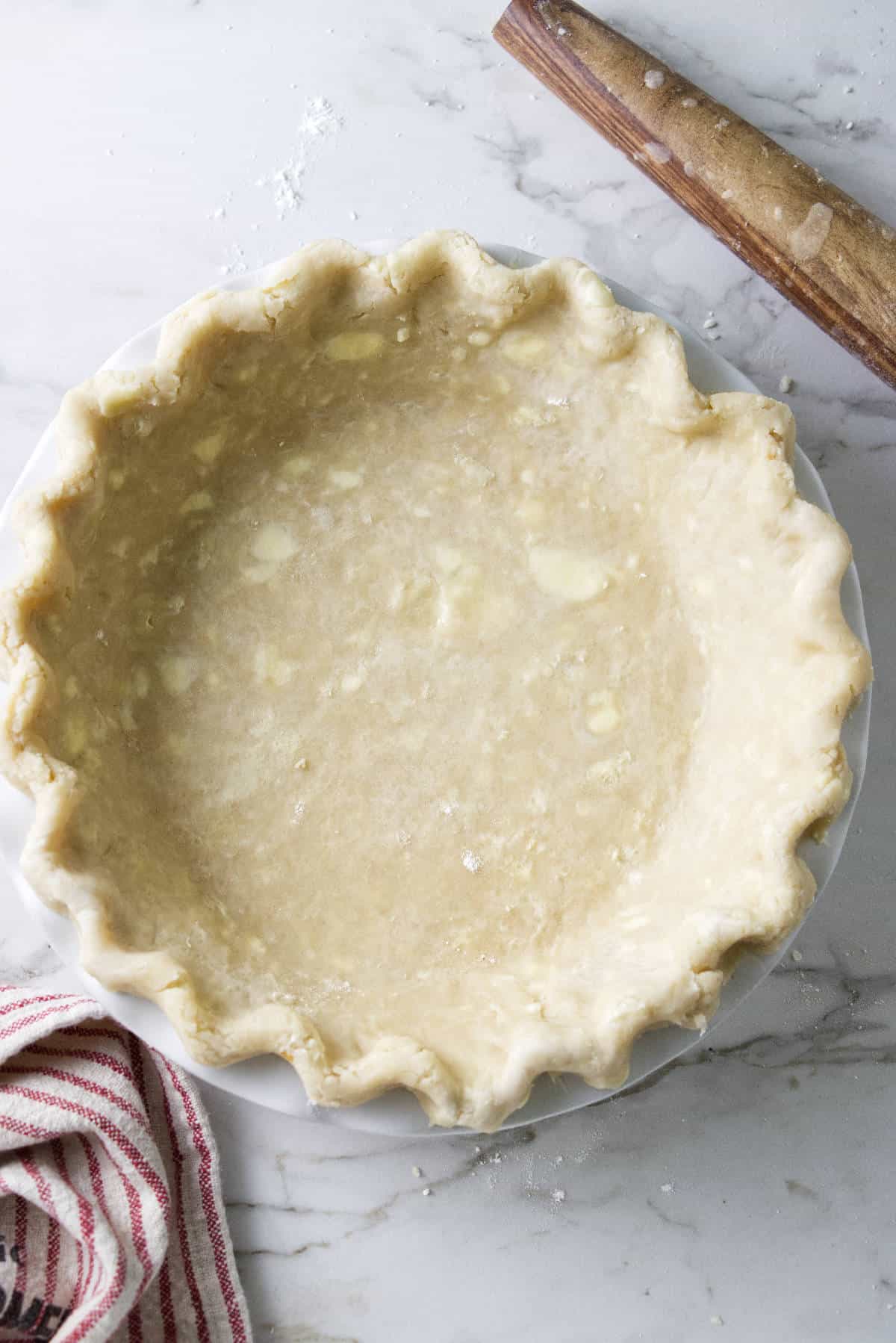 pie crust prepared in pie pan to be baked.