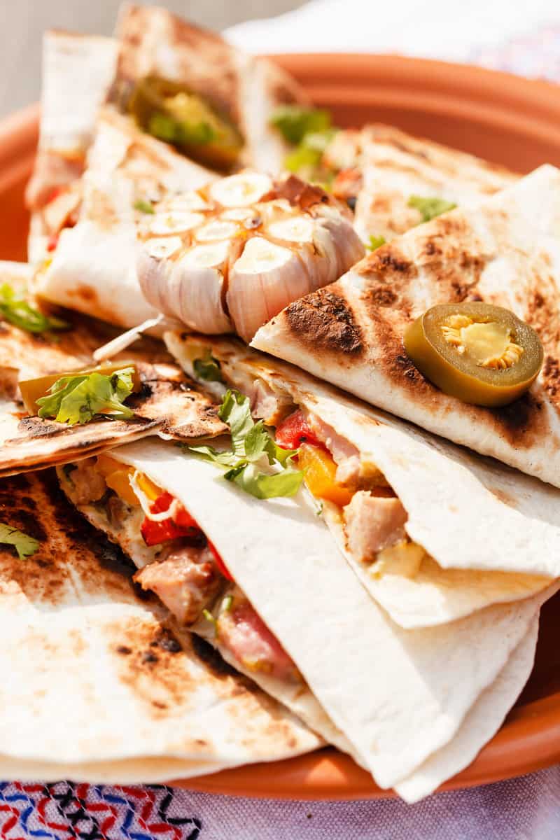 Steak quesadilla made with a homemade flour tortilla and topped with pickled jalapenos.