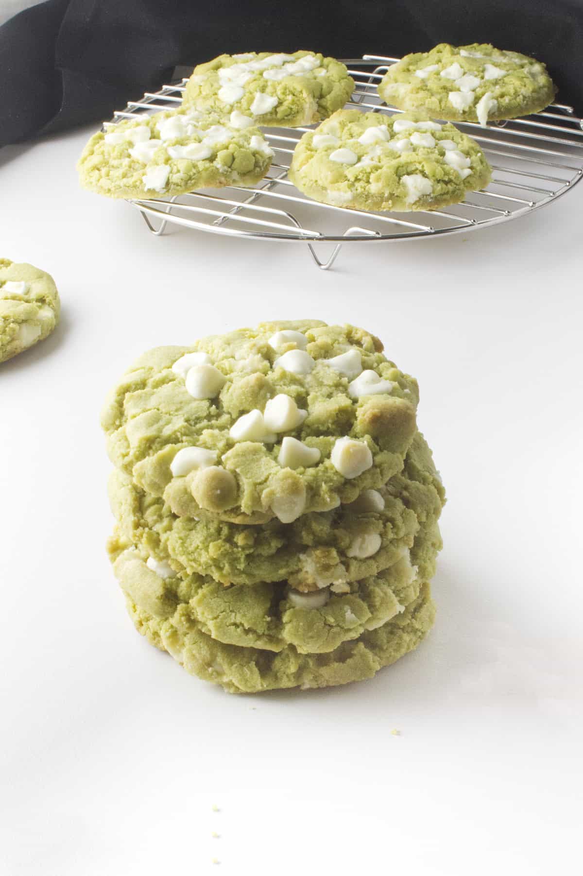 stack of matcha green tea cookies with white chocolate chips.
