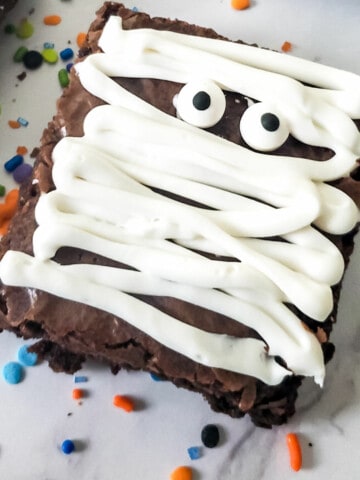 close up of one brownie frosted like a mummy.