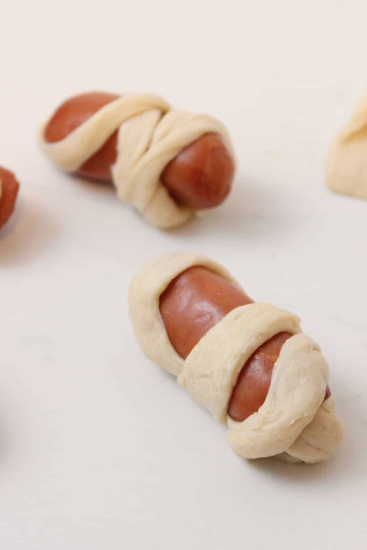 mini hot dogs wrapped in crescent roll dough strips.