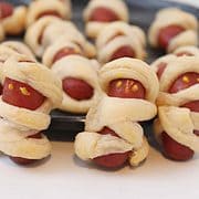 plate of mini crescent roll wrapped hot dogs.