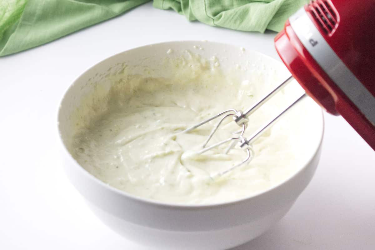 cream cheese filling being mixed in a bowl.