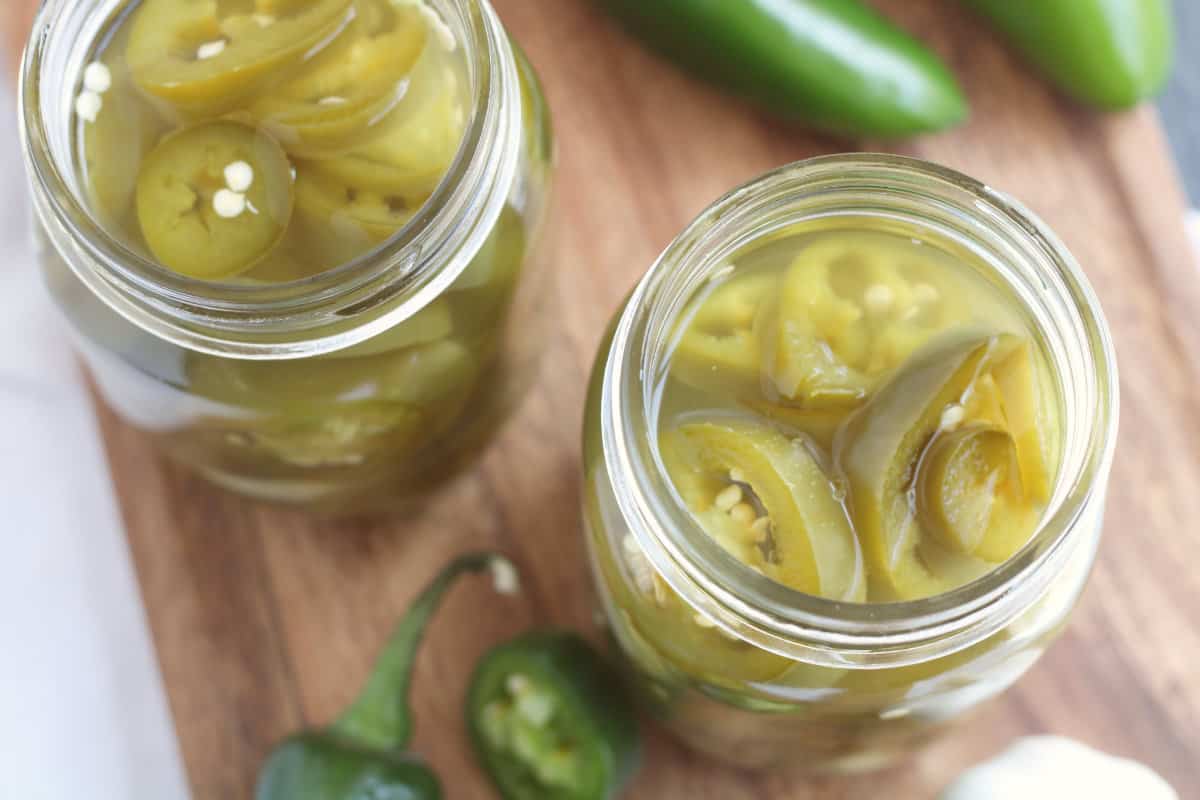 pickeled jalapenos in a canning jar.