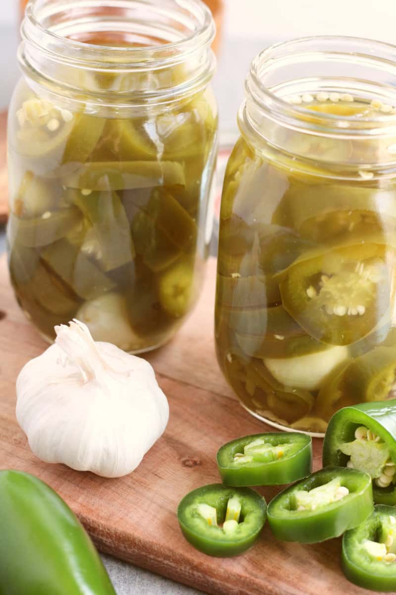 ball canning jars filled with pickled jalapenos.