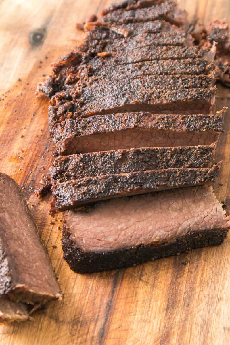 slices of smoked brisket on a cutting board.