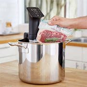 sous vide machine with sealed steak.