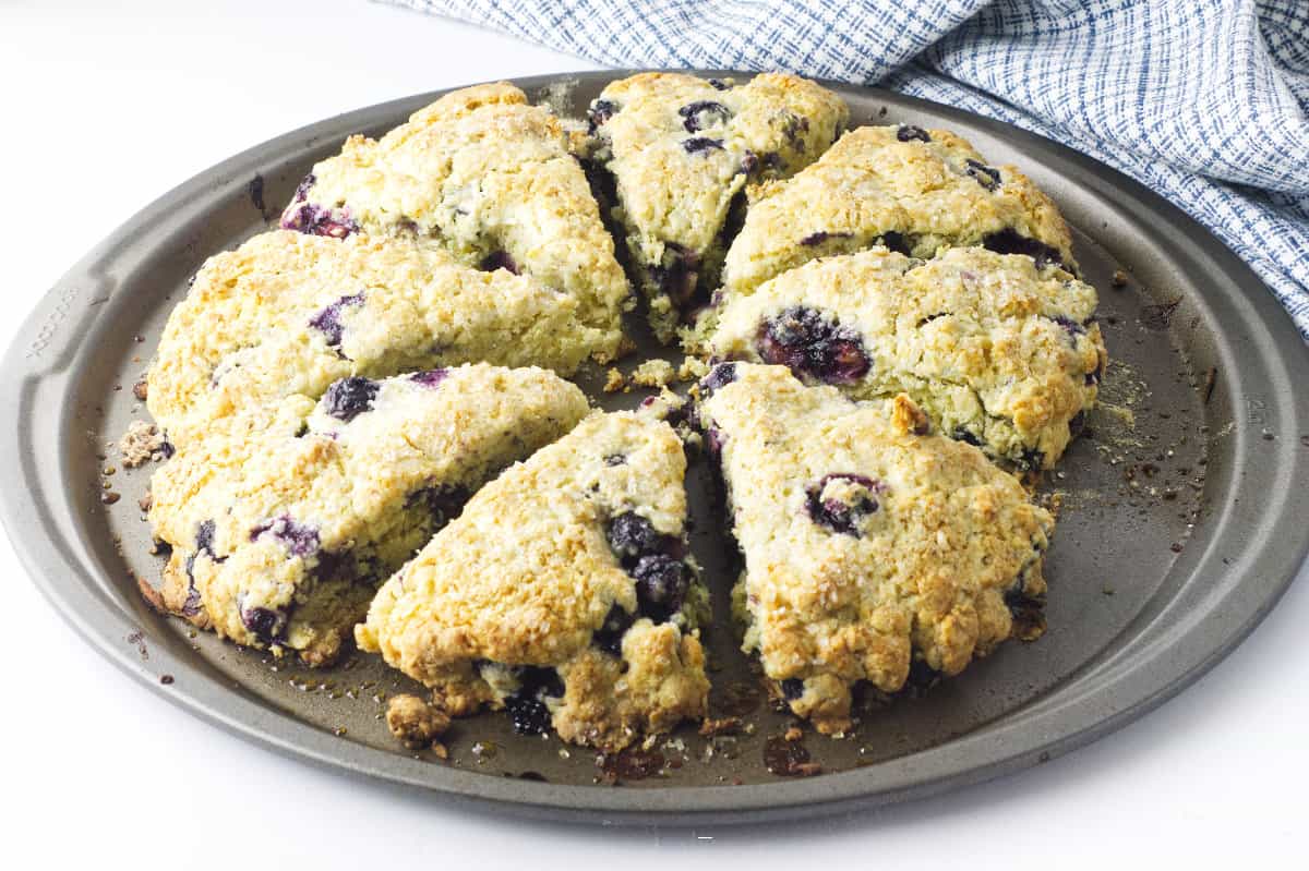 baking sheet with eight wedges of blueberry scones.