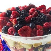 a large clear glass trifle bowl filled with a layered berry trifle
