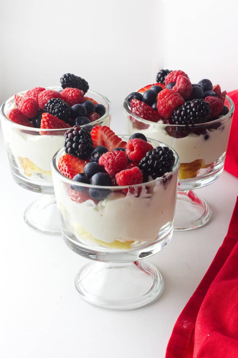 three mini summer berry trifles in clear class mini trifle bowls.