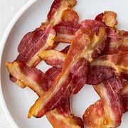 air fryer bacon on a plate.