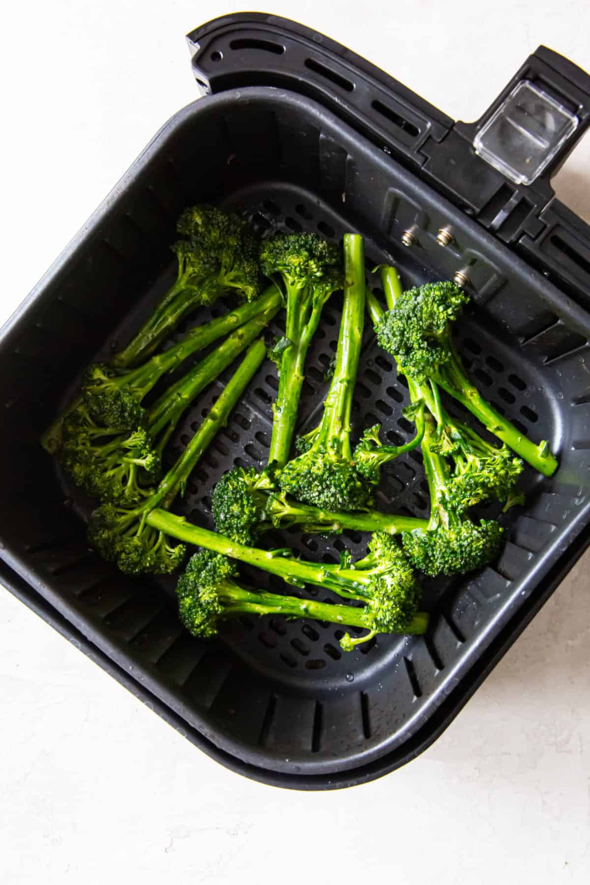 broccolini in the air fryer before cooking.