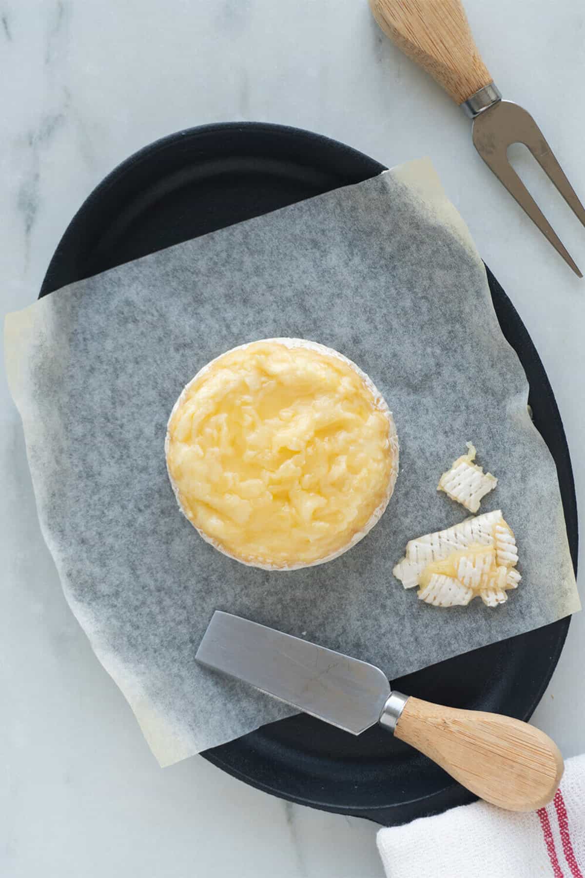 shaving the top rind off of a brie.