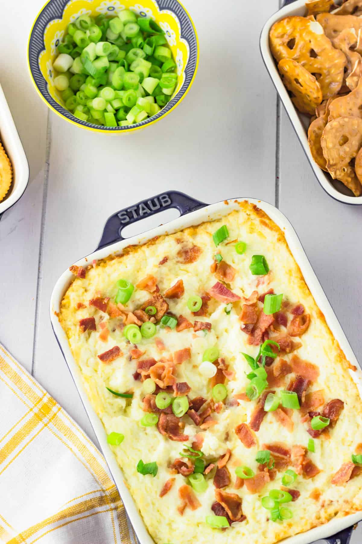 loaded ranch dip with garnishes in a casserole.