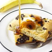 syrup drizzled on a stack or banana chocolate chip pancakes.