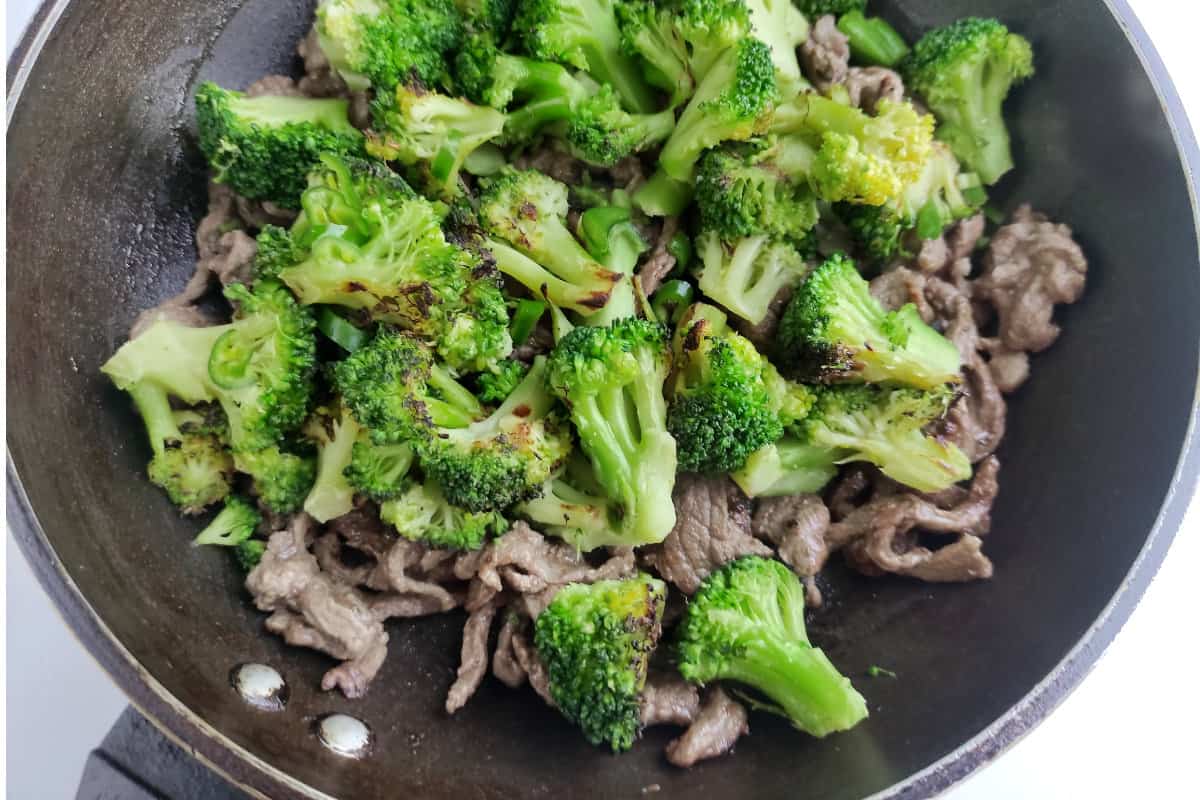 skillet with beef and broccoli cooking.