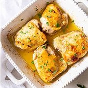 broiled chicken thighs in a serving dish.