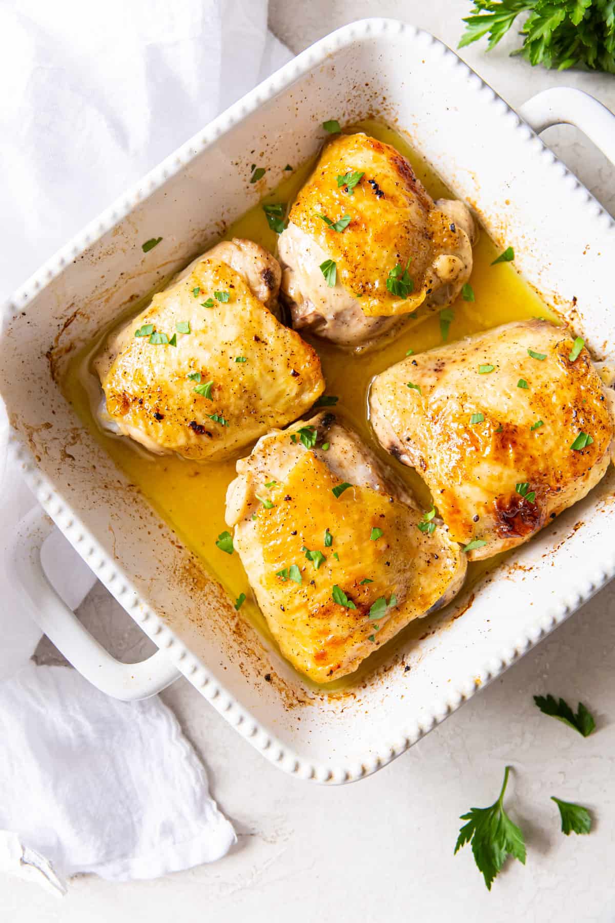 broiled chicken thighs in a serving dish.