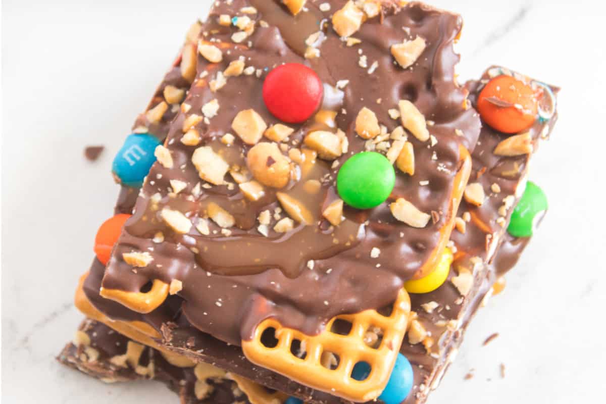 chocolate covered caramel pretzel bark with peanuts and M&M's.
