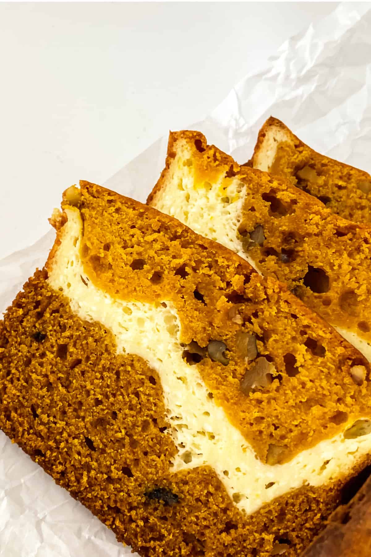 Slices of pumpkin bread with cream cheese filling.