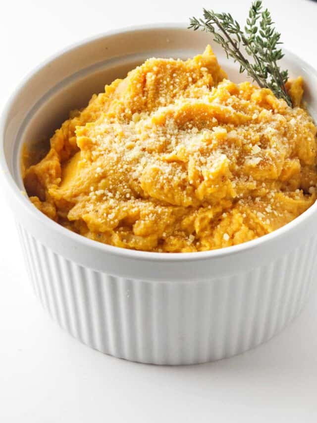 serving bowl with thyme garnished mashed sweet potatoes. Savory halloween party food idea.
