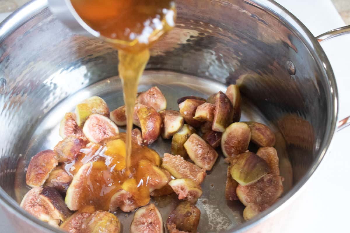 adding juice and honey to cooking figs.