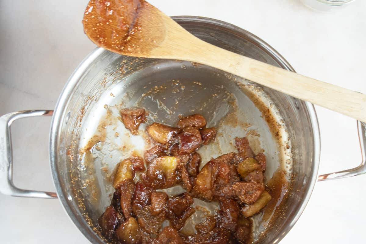 fig jam thickening in a stainless steel pot.