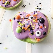 purple candy apple slices with halloween sprinkles.