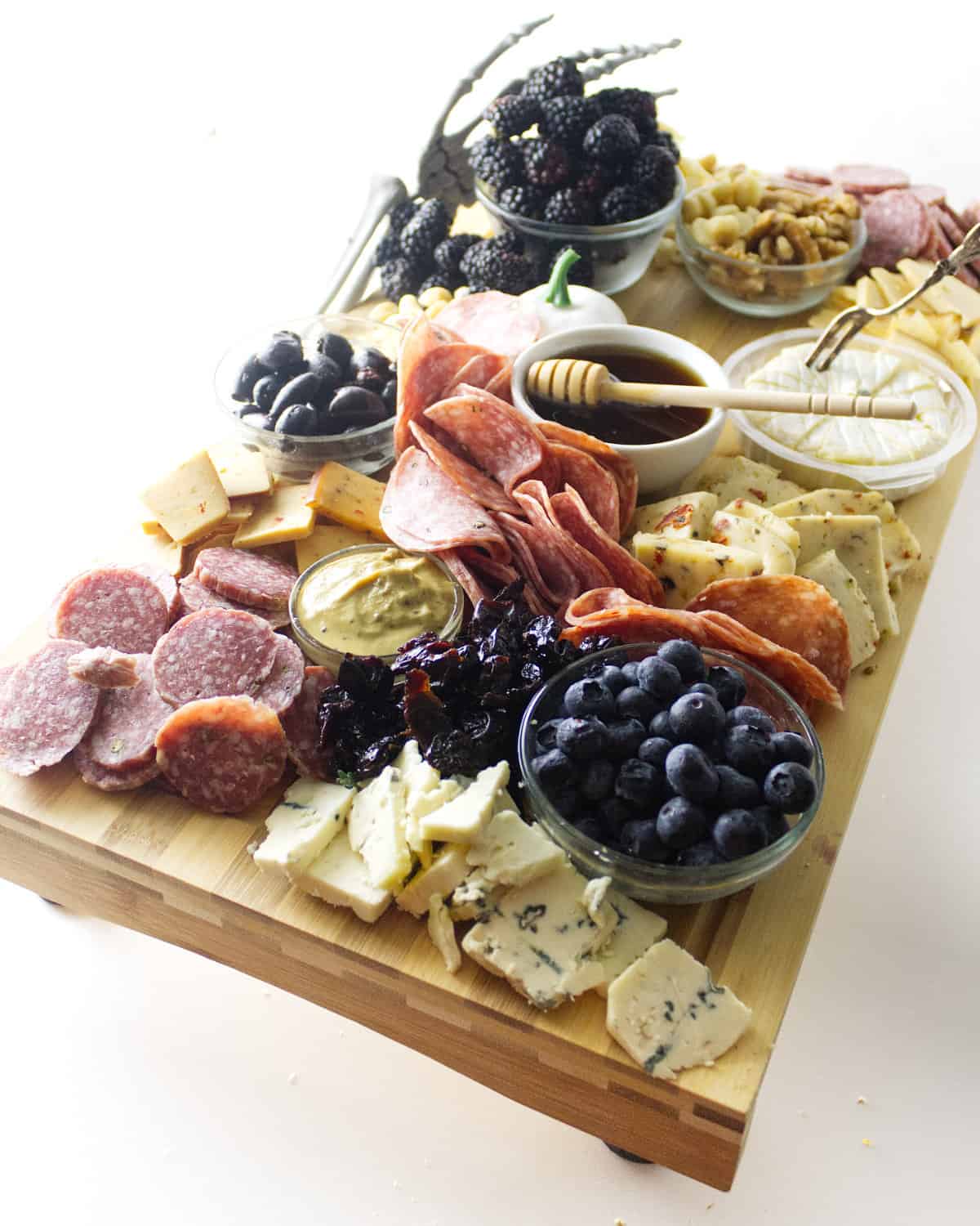 meats added with more cheese and fruit to platter.