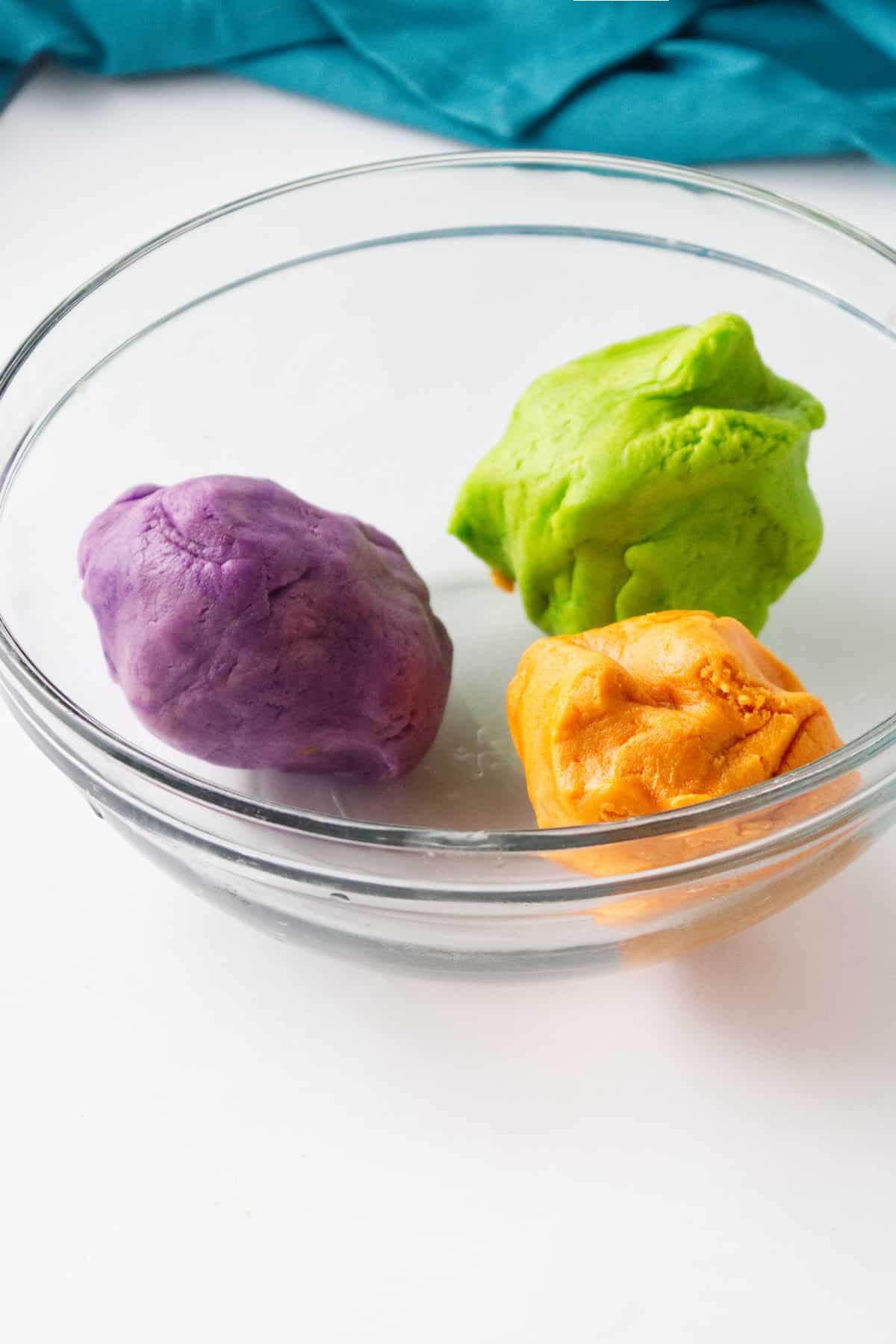 three balls of colored cookie dough.