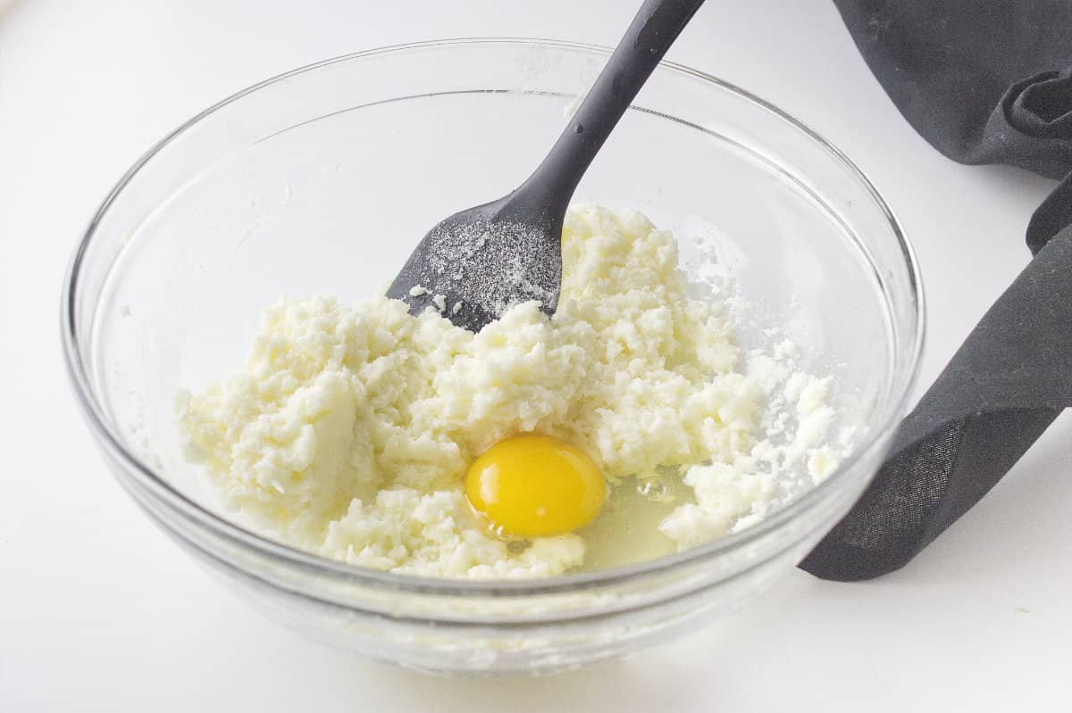 egg added to bowl of sugar and butter.