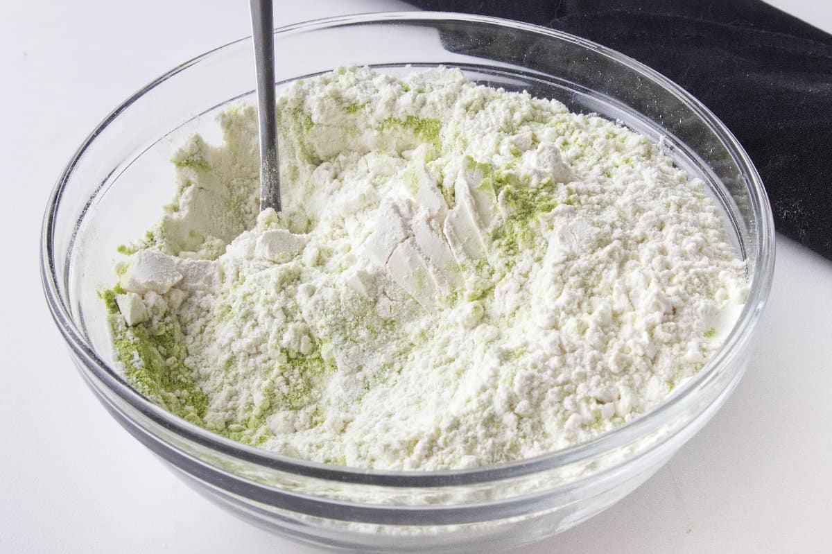 green matcha tea powder mixed into dry ingredients.