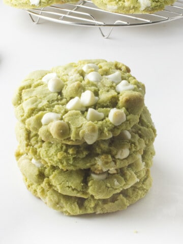 stack of matcha green tea cookies with white chocolate chips.
