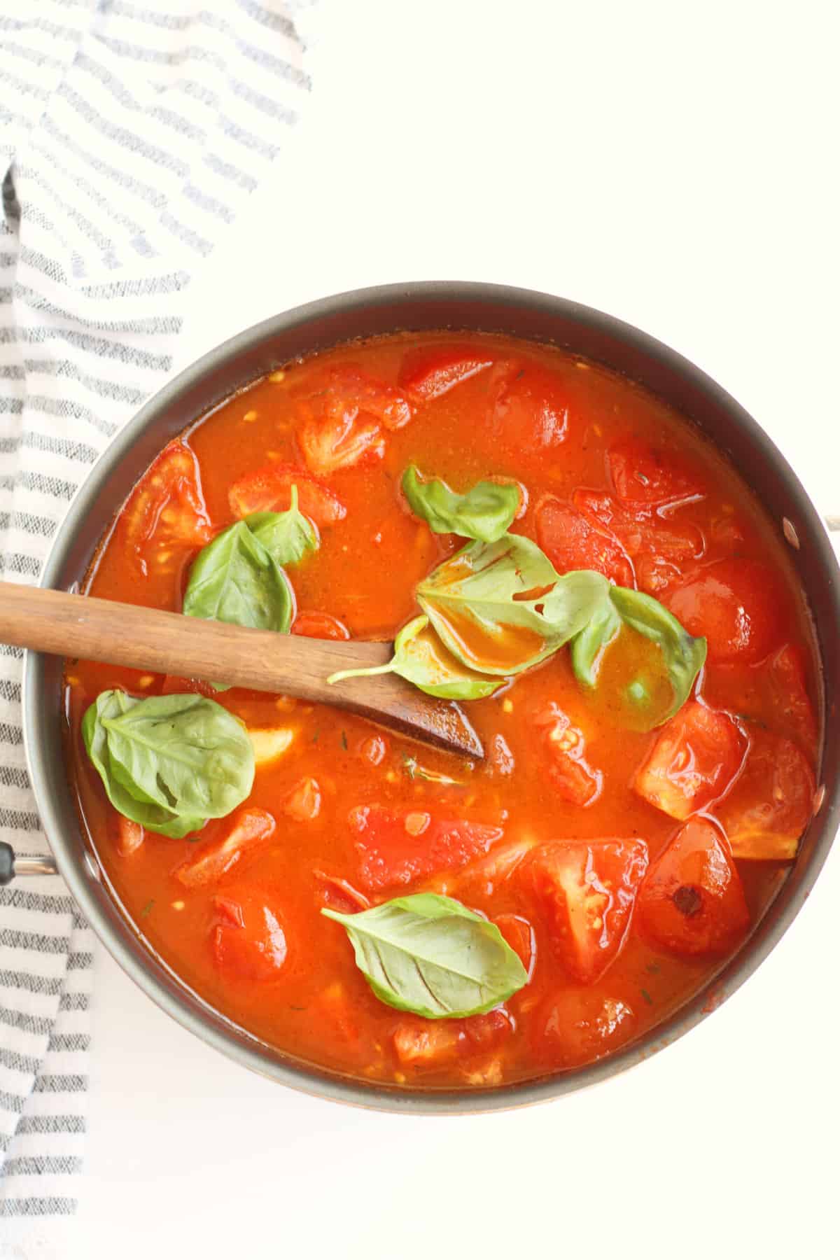 tomatoes and basil in pot for soup.