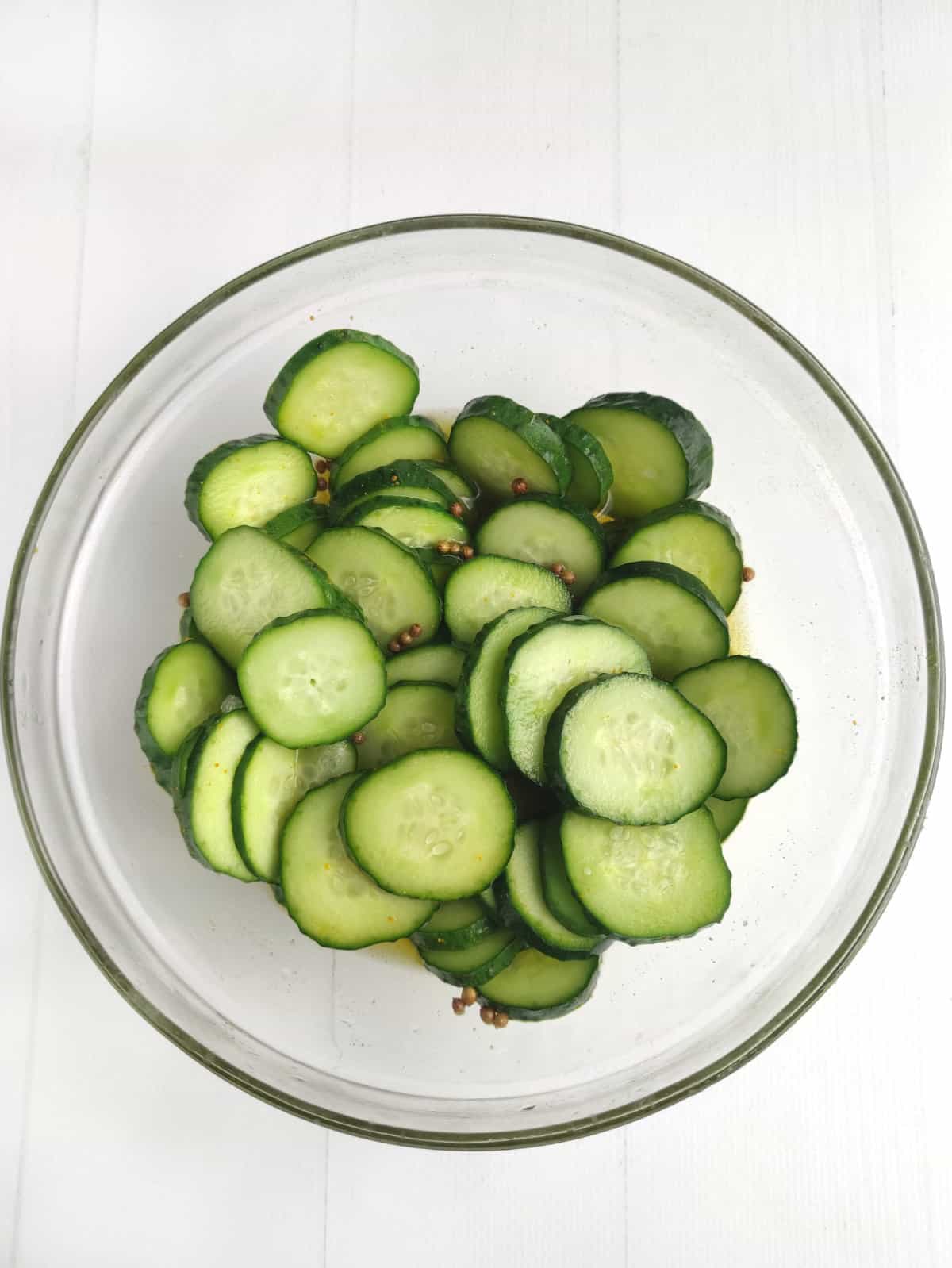 cucumber slices brining for sweet bread and butter pickle slices.
