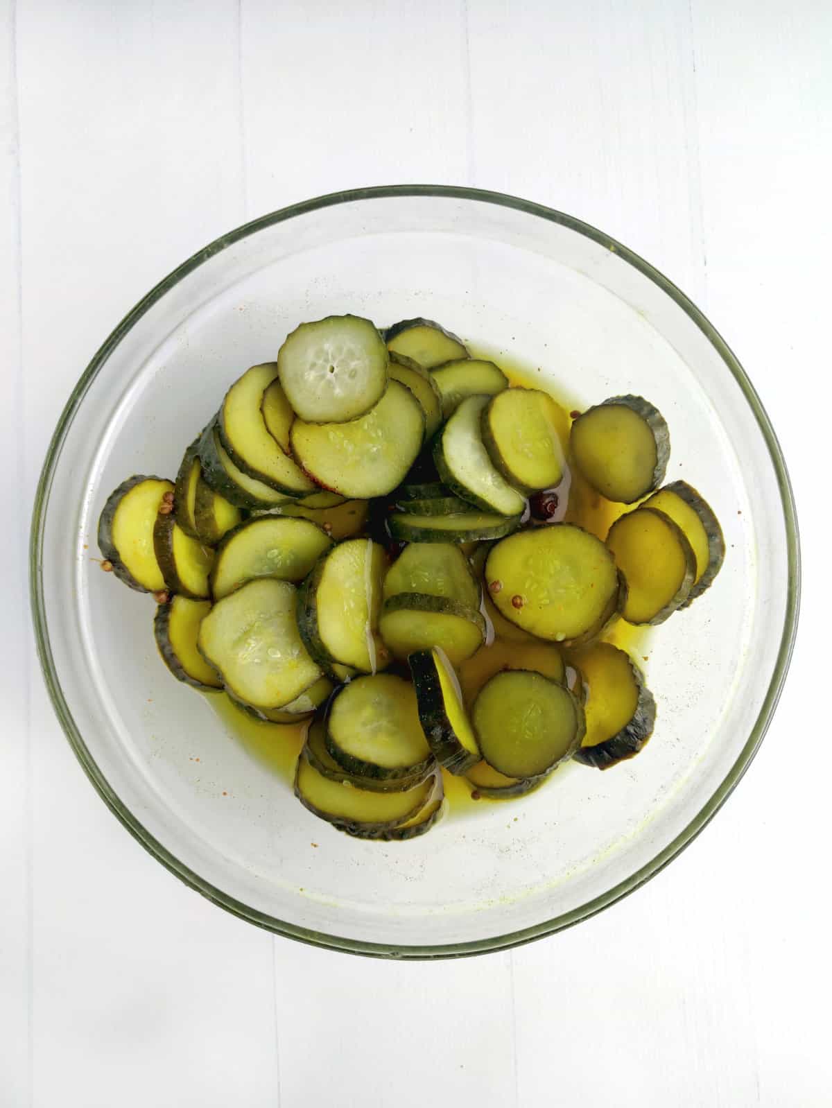 bowl of cured cucumber slices into sweet pickle slices or chips.
