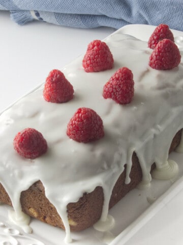 Raspberry topped loaf cake with white glaze.