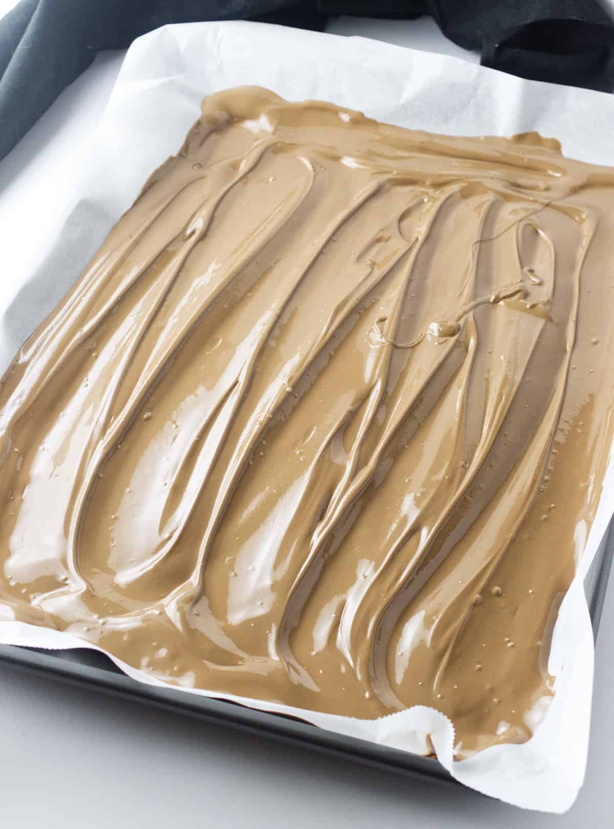 melted milk chocolate on a cookie sheet.