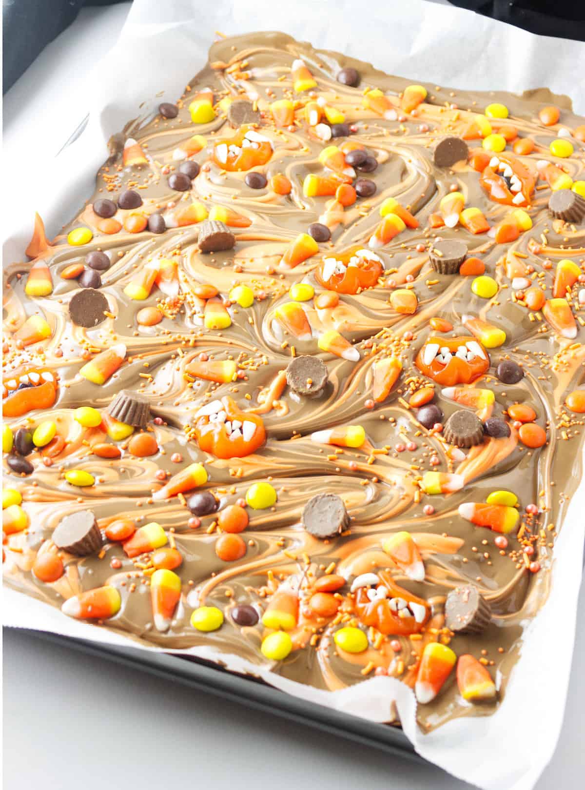 tray of decorated with brittle with corn and reeses pieces.