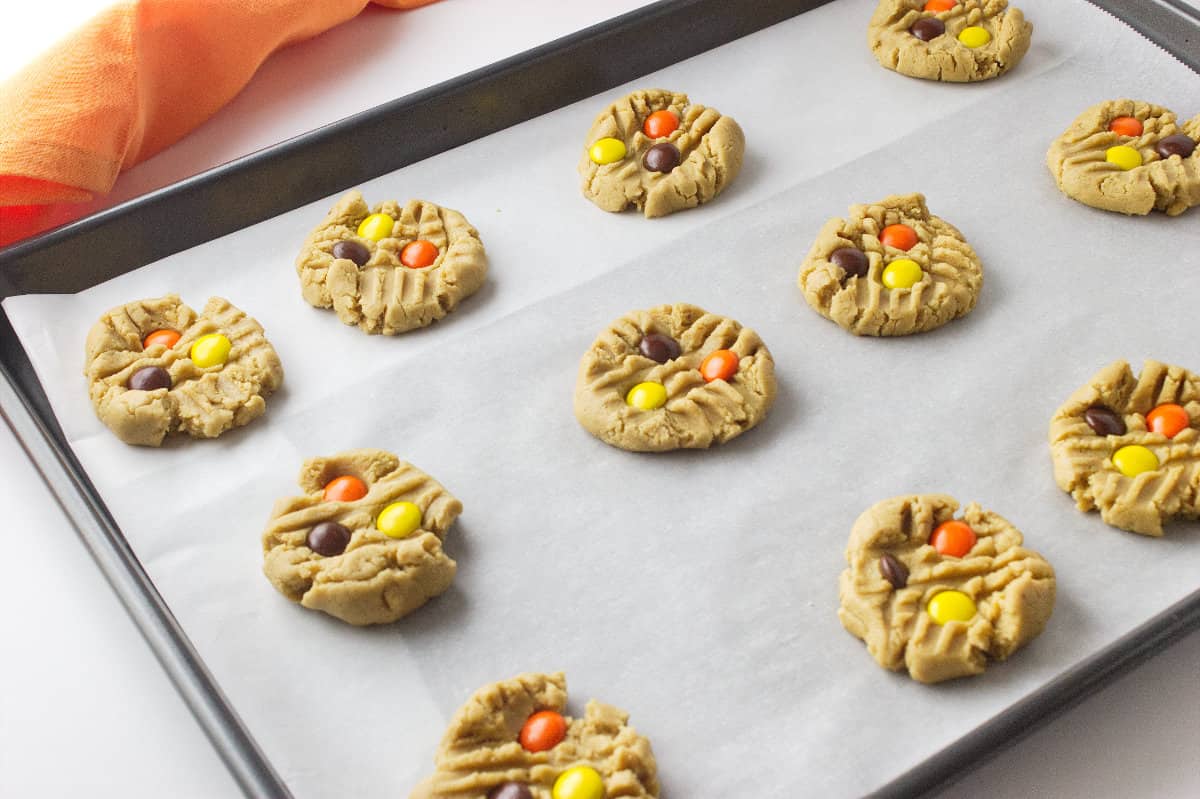 Reese's pieces pressed into cookie dough.