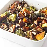 roasted brussels sprouts and sweet potatoes in a serving dish.
