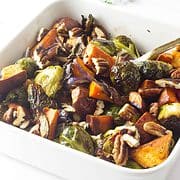 roasted brussels sprouts and sweet potatoes in a serving dish.