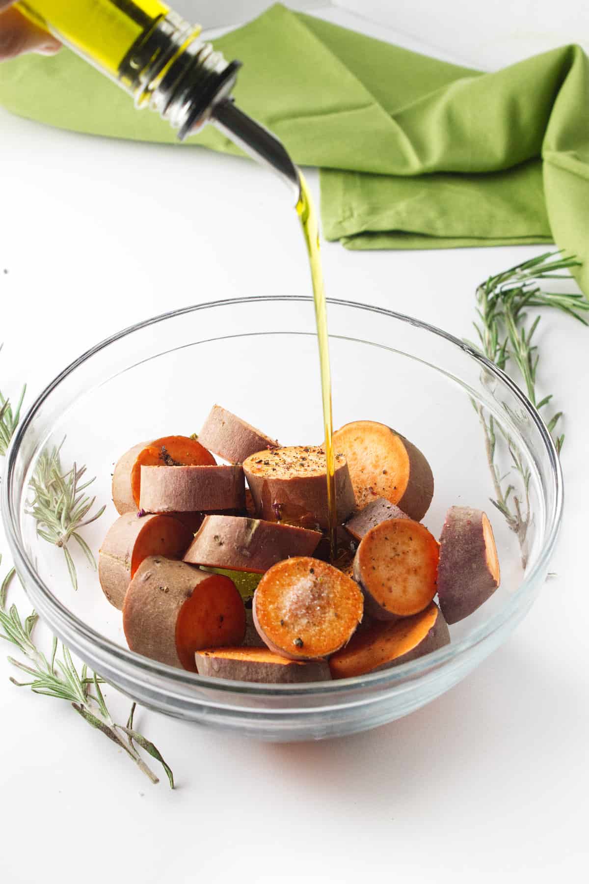 sliced sweet potatoes drizzled with olive oil.