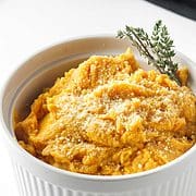 serving bowl with thyme garnished mashed sweet potatoes.