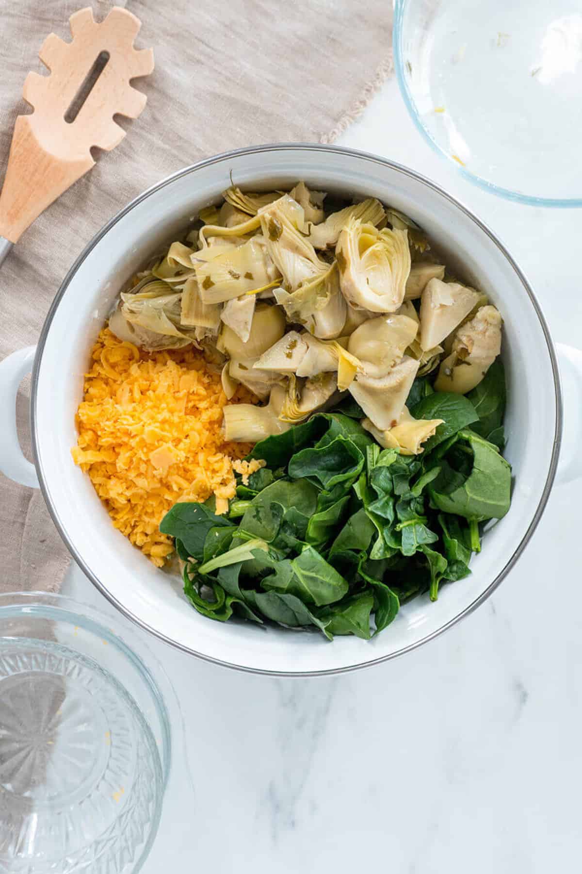 cheese, artichoke, and spinach in a bowl.