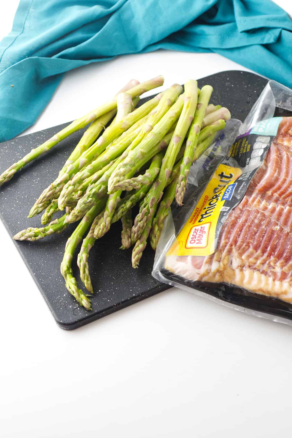fresh washed asparagus and package of bacon.