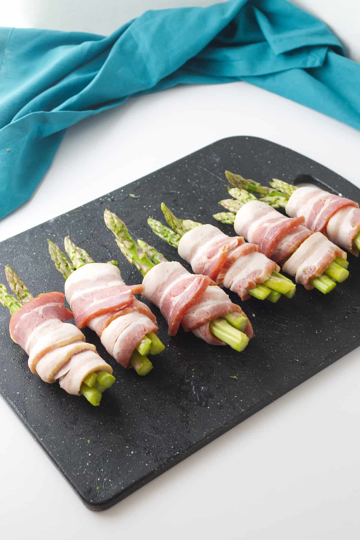 wrapping asparagus in bacon strips.